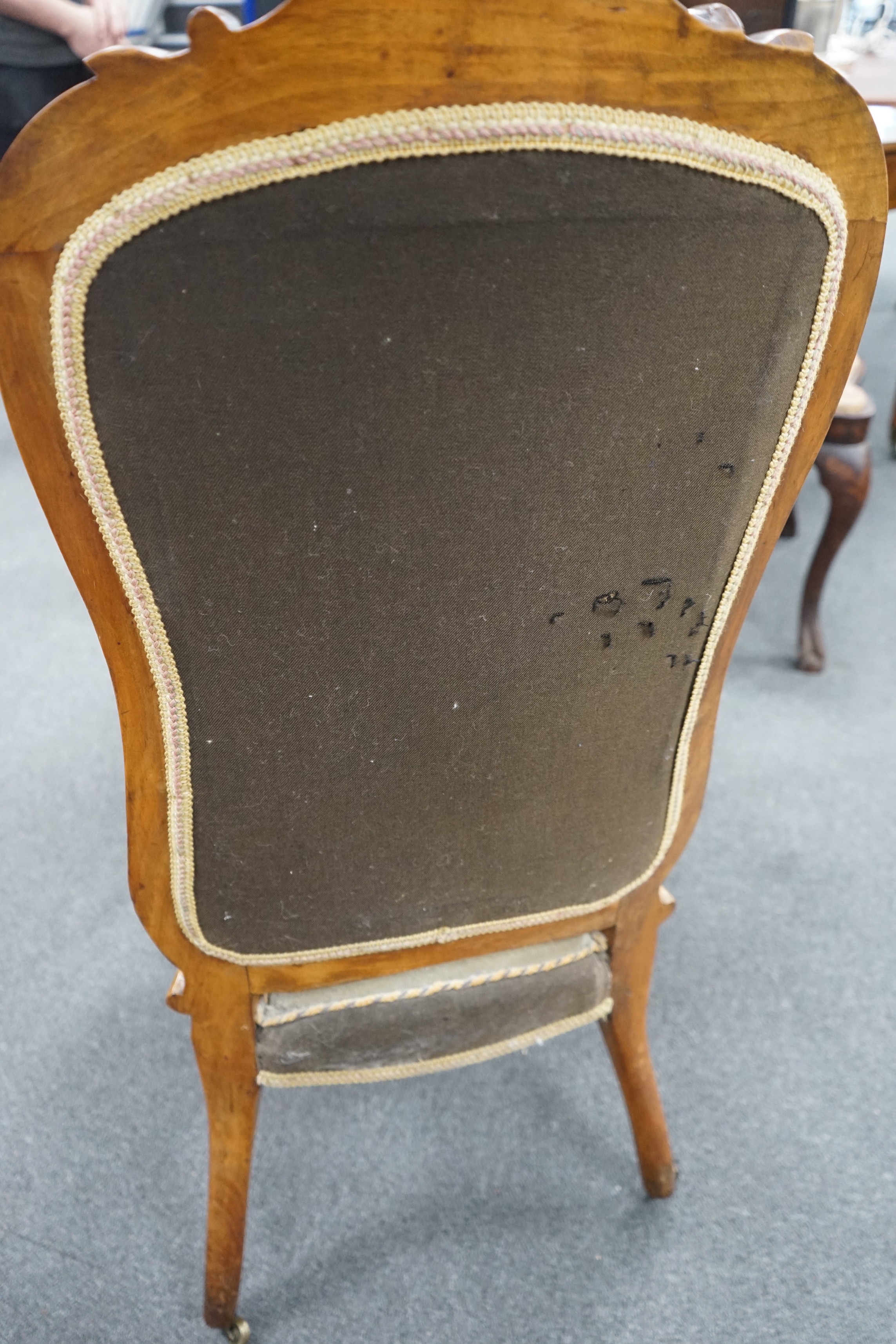 A Victorian carved walnut nursing chair with floral embroidered upholstery, height 112cm